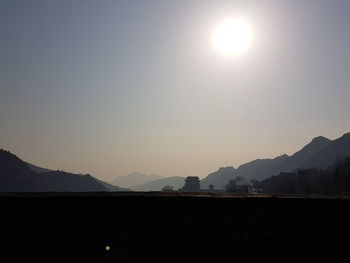 Scenic view of silhouette mountains against sky at sunset