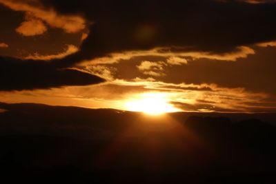 Scenic view of silhouette mountains against sky during sunset
