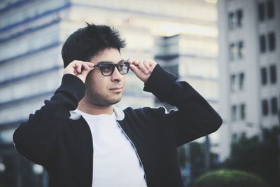 Portrait of young man standing outdoors