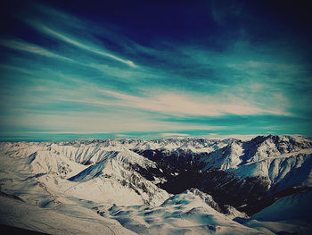 Scenic view of dramatic landscape against sky during winter