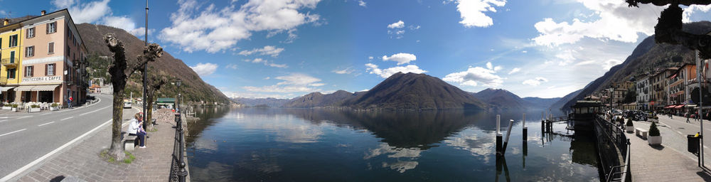 Panoramic view of buildings and mountains against sky