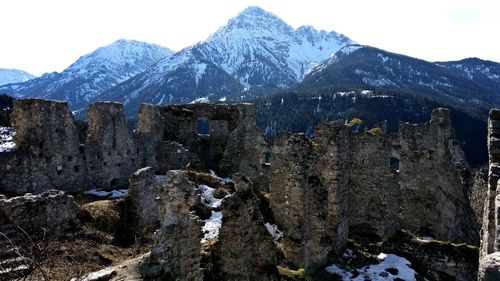 View of old ruin against mountains against sky