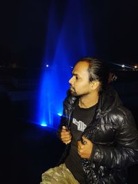 Man looking at illuminated fireworks at night