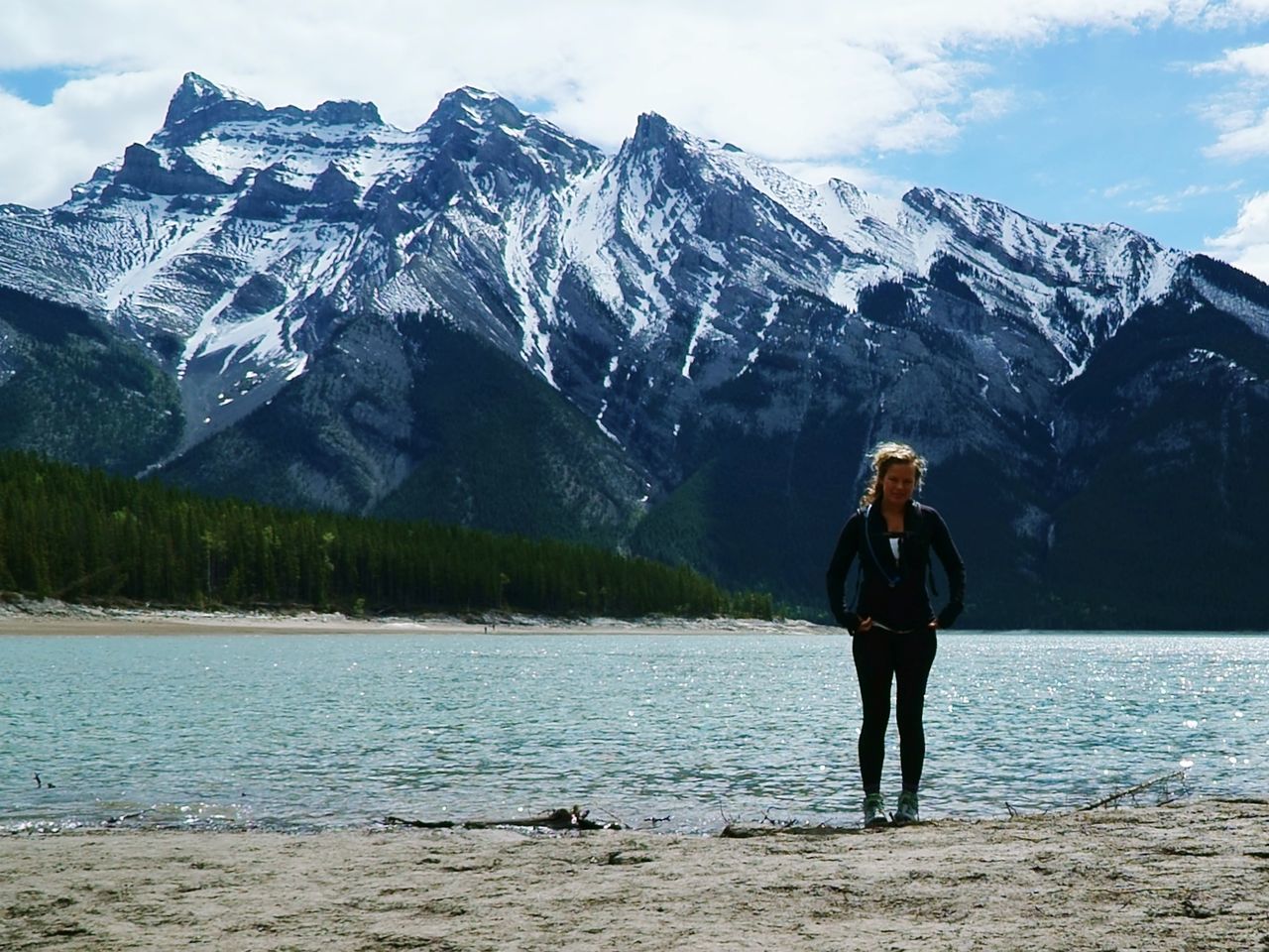 FULL LENGTH OF SENIOR WOMAN STANDING ON LAKE AGAINST MOUNTAIN