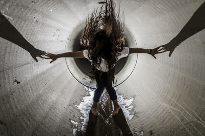 High angle view of woman standing by built structure