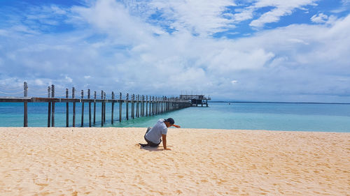 Man on beach against sky