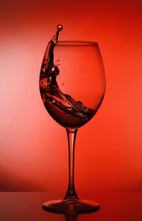 Close-up of wineglass against yellow background