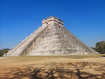 Low angle view of temple against clear blue sky