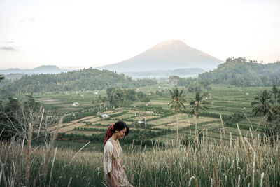 Side view of man standing in field