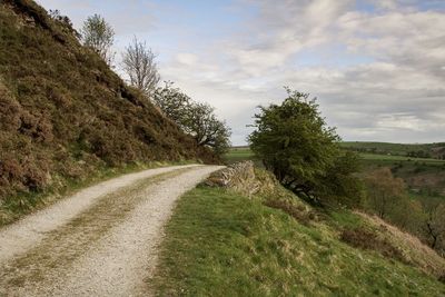 Empty road along countryside landscape