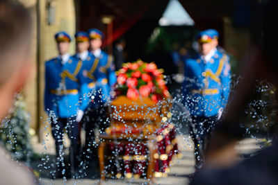 Splashing water drops in front of honor guards around coffin