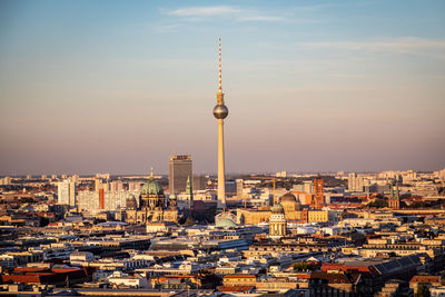 Fernsehturm against sky during sunset