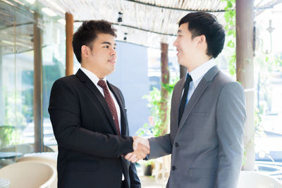 Young man and woman standing in front of two people