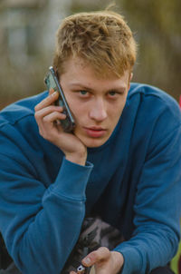 Portrait of young man using mobile phone