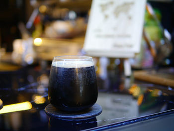 Close-up of beer glass on table