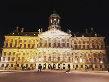 Group of people in front of building at night