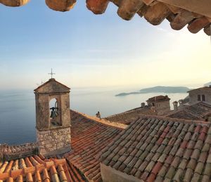 Historic building by sea against sky