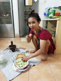 Woman sitting on table at home