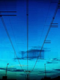 Low angle view of cables against blue sky