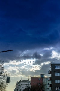 Low angle view of building against cloudy sky
