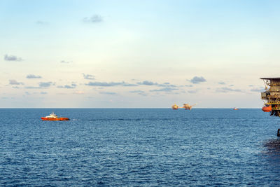 A fast crew boat leaving an oil production platform for a crew change at offshore oil field