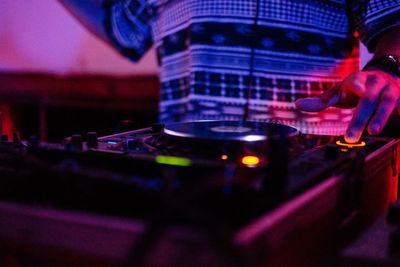 Midsection of do mixing at nightclub