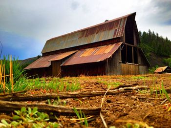 Low angle view of old abandoned building against sky