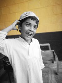 Portrait of smiling boy standing outdoors