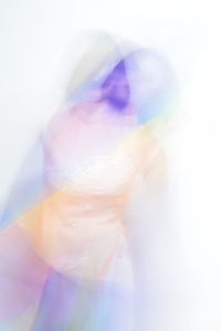 Close-up of human hand against colored background