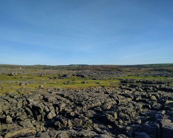 Scenic view of landscape against blue sky