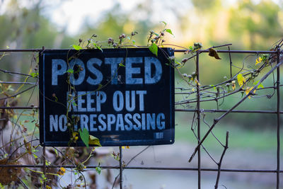 Close-up of signboard against blurred background