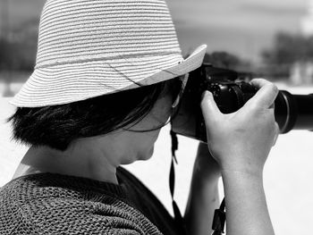 Rear view of woman photographing outdoors