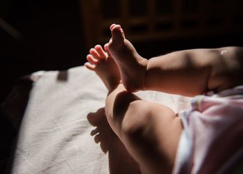 Close-up of baby feet on bed