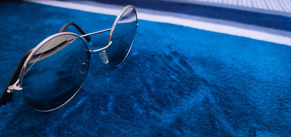 High angle view of sunglasses in swimming pool