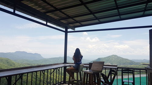 Woman sitting on observation point