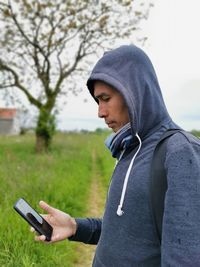 Midsection of man using mobile phone