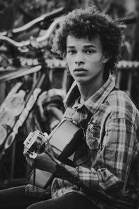 Portrait of young man sitting outdoors