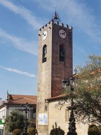 Low angle view of clock tower against sky