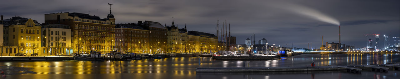 A beautiful panorama cityscape of an illuminated downtown district of helsinki waterfront.