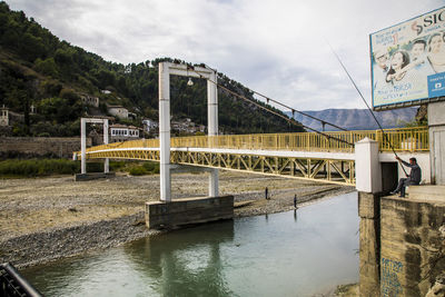 Bridge over river against sky