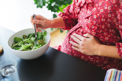 Midsection of woman eating food