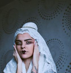 Portrait of young woman with make-up wearing headscarf