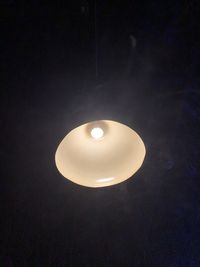 High angle view of illuminated lamp against black background