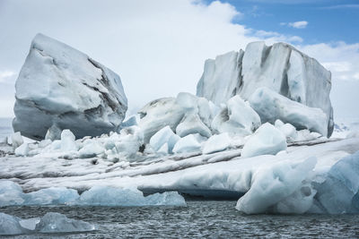 Close-up of icebergs against sky