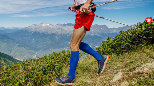 Low section of man walking on mountain