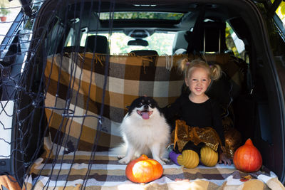 Portrait of girl sitting in car