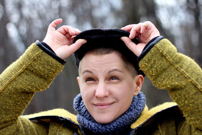 Smiling woman looking away wearing hat during winter