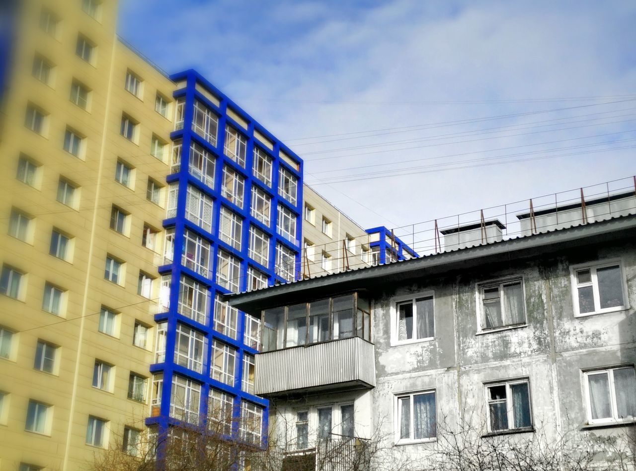 building exterior, architecture, built structure, city, sky, low angle view, building, blue, residential building, window, residential structure, day, modern, outdoors, cloud, cloud - sky, house, residential district, no people, city life