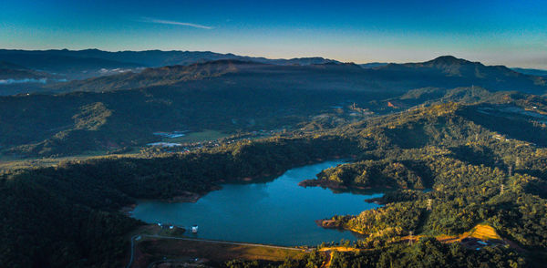 High angle view of lake and mountains against sky