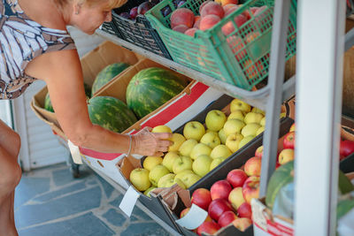 High angle view of woman holding fruits for sale